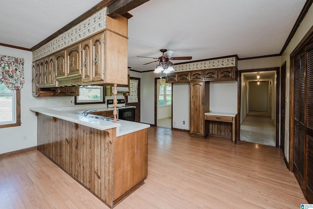kitchen with range with electric stovetop, light countertops, crown molding, and light wood-type flooring