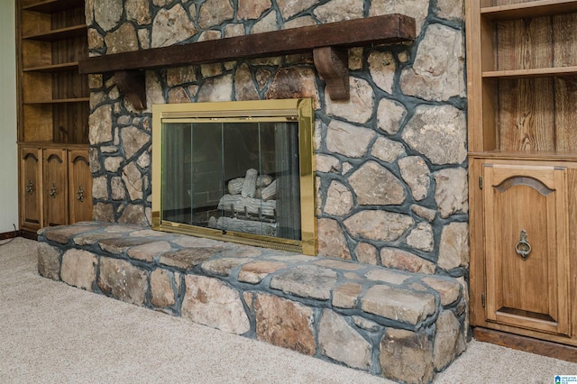 room details featuring built in shelves, carpet, and a fireplace