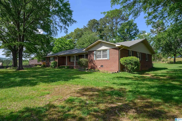 exterior space with brick siding, crawl space, covered porch, and a front lawn