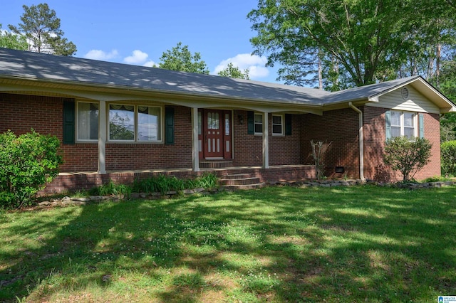 single story home featuring brick siding and a front yard