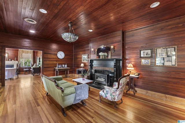 living room featuring visible vents, a brick fireplace, wood finished floors, recessed lighting, and wood ceiling