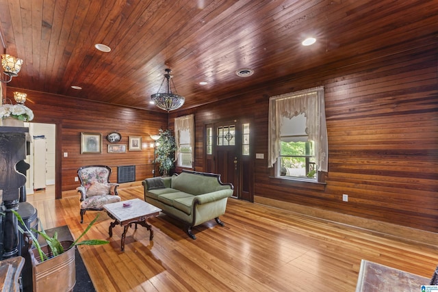 living room with recessed lighting, wood walls, hardwood / wood-style floors, and wooden ceiling