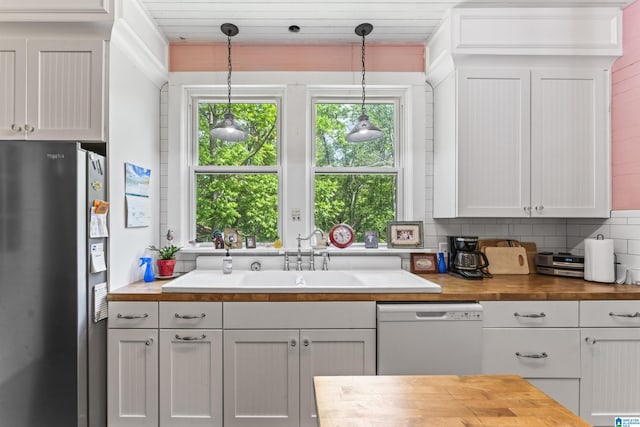 kitchen with wood counters, tasteful backsplash, stainless steel fridge with ice dispenser, and dishwasher