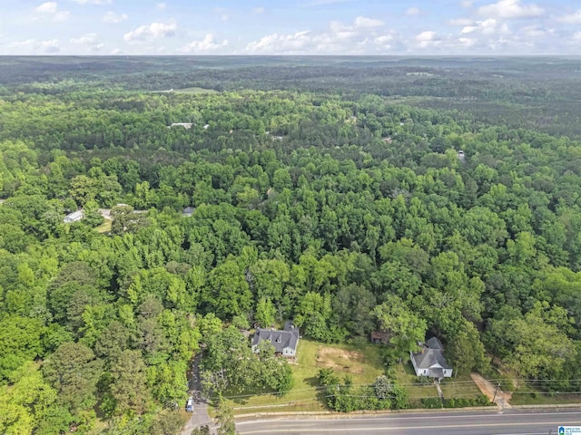 bird's eye view featuring a wooded view