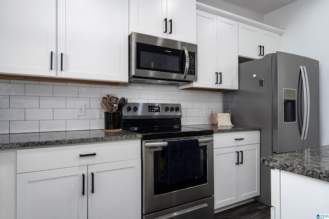8659 Clarke Ln, Leeds, AL 35094 - kitchen with appliances with stainless steel finishes, backsplash, dark stone countertops, and white cabinetry