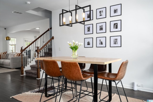 8659 Clarke Ln, Leeds, AL 35094 - dining room featuring visible vents, wood finished floors, stairway, and an inviting chandelier