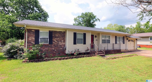 ranch-style home featuring an attached garage, brick siding, a front yard, and metal roof