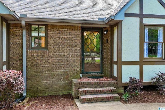 6522 Quail Run Dr, Pelham, AL 35124 - view of exterior entry with roof with shingles, brick siding, and stucco siding