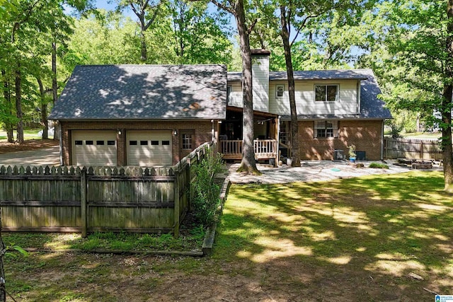 6522 Quail Run Dr, Pelham, AL 35124 - back of house with a chimney, brick siding, a garage, and a wooden deck
