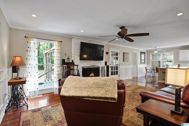 6522 Quail Run Dr, Pelham, AL 35124 - living room featuring ornamental molding, healthy amount of natural light, ceiling fan, a brick fireplace, and a decorative wall