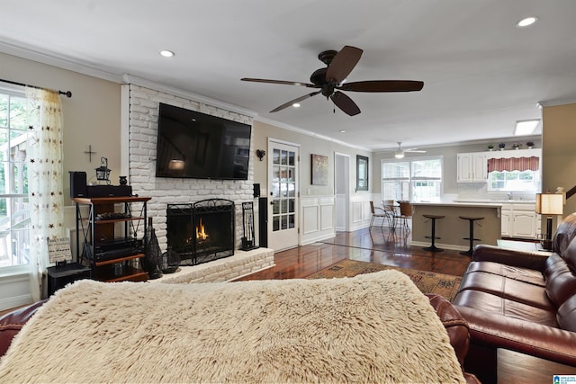 6522 Quail Run Dr, Pelham, AL 35124 - living room with dark wood-type flooring, crown molding, ceiling fan, healthy amount of natural light, and a brick fireplace