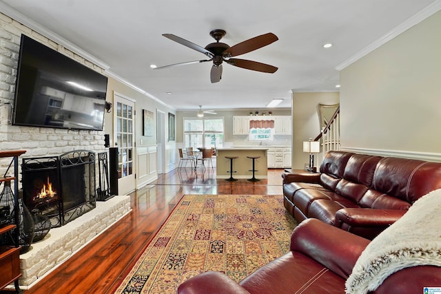 6522 Quail Run Dr, Pelham, AL 35124 - living area with crown molding, ceiling fan, wood finished floors, a brick fireplace, and recessed lighting
