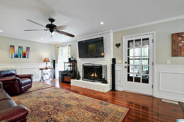6522 Quail Run Dr, Pelham, AL 35124 - living area with crown molding, plenty of natural light, a brick fireplace, a ceiling fan, and wood finished floors