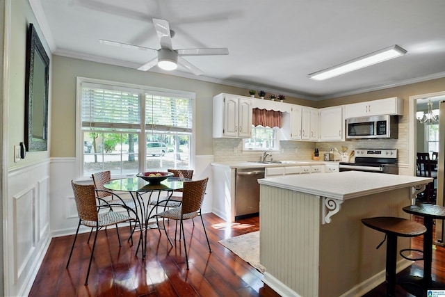 6522 Quail Run Dr, Pelham, AL 35124 - kitchen featuring stainless steel appliances, dark wood finished floors, light countertops, white cabinetry, and a breakfast bar area
