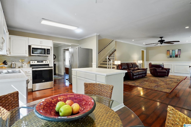 6522 Quail Run Dr, Pelham, AL 35124 - dining space with stairs, dark wood-style floors, ornamental molding, a wainscoted wall, and a ceiling fan