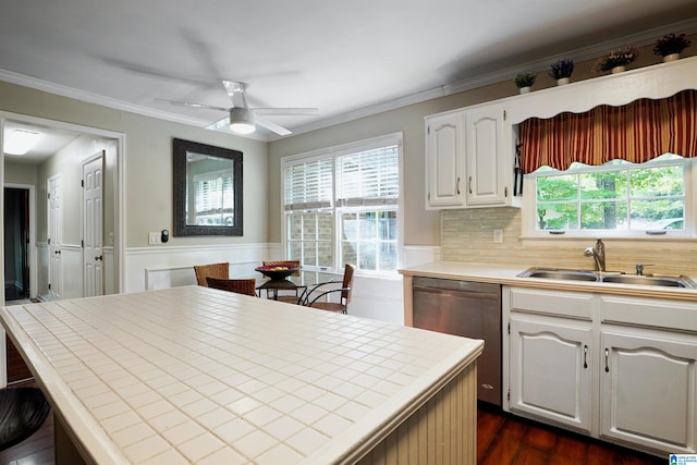 6522 Quail Run Dr, Pelham, AL 35124 - kitchen with a sink, stainless steel dishwasher, tile counters, ceiling fan, and white cabinets