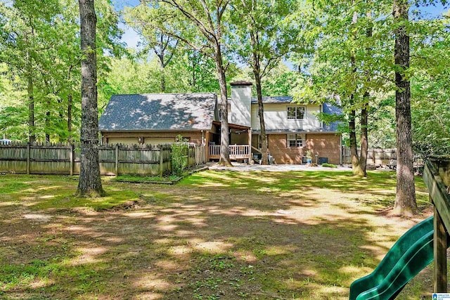 6522 Quail Run Dr, Pelham, AL 35124 - back of property with brick siding, a garage, and a deck