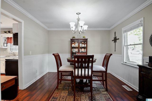 6522 Quail Run Dr, Pelham, AL 35124 - dining space with dark wood-style floors, a chandelier, and crown molding
