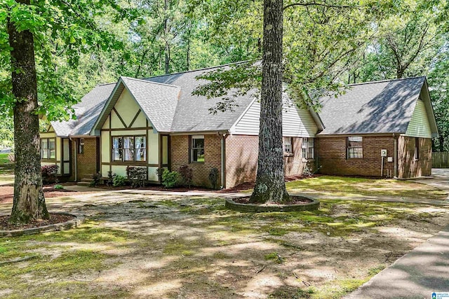 6522 Quail Run Dr, Pelham, AL 35124 - tudor-style house featuring brick siding and a shingled roof