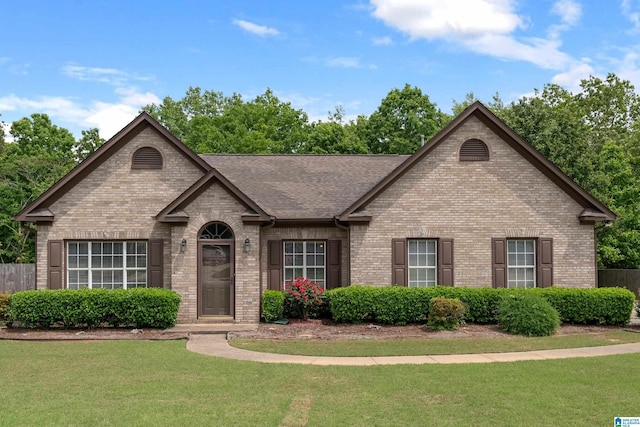 view of front facade featuring a front yard and brick siding
