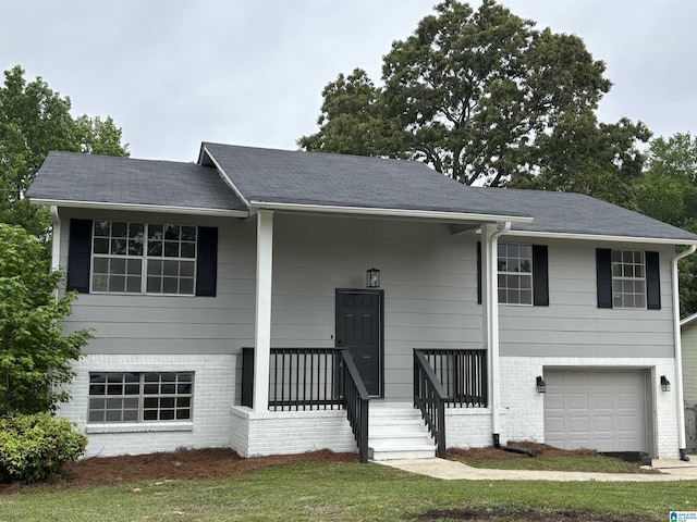 raised ranch with brick siding and an attached garage