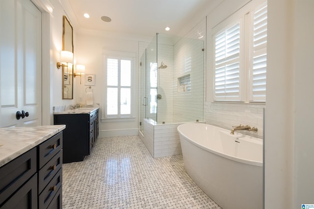 bathroom with recessed lighting, two vanities, a soaking tub, a sink, and a shower stall