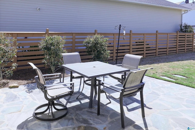 view of patio with fence and outdoor dining area