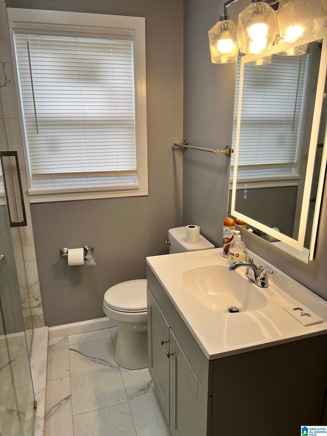 full bathroom with vanity, marble finish floor, toilet, baseboards, and an enclosed shower