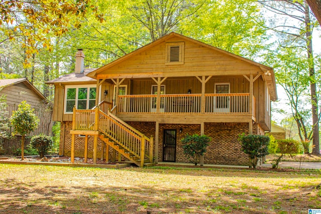 view of front of property featuring board and batten siding, stairway, a chimney, and a wooden deck
