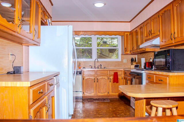 kitchen featuring decorative backsplash, black microwave, light countertops, electric range oven, and under cabinet range hood