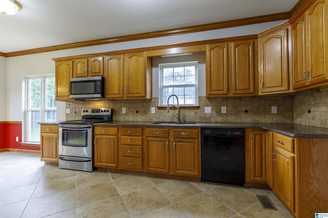 5251 Vintage Way, Mccalla, AL 35111 - kitchen with brown cabinetry, a sink, appliances with stainless steel finishes, and crown molding