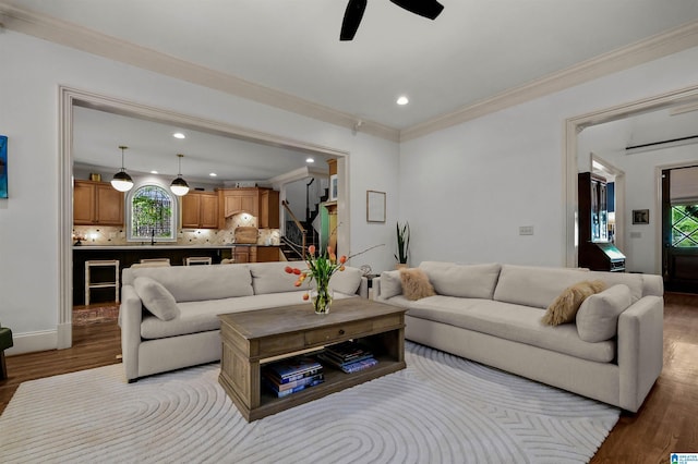 living room featuring crown molding, wood finished floors, ceiling fan, and recessed lighting