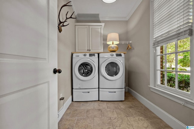 washroom featuring cabinet space, ornamental molding, washing machine and clothes dryer, a wealth of natural light, and baseboards