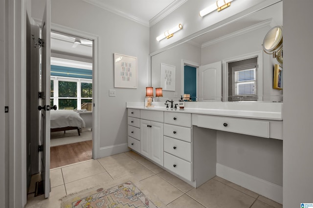 ensuite bathroom with baseboards, ensuite bathroom, ornamental molding, tile patterned floors, and vanity