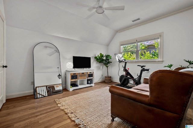 living room with wood finished floors, visible vents, vaulted ceiling, a ceiling fan, and baseboards