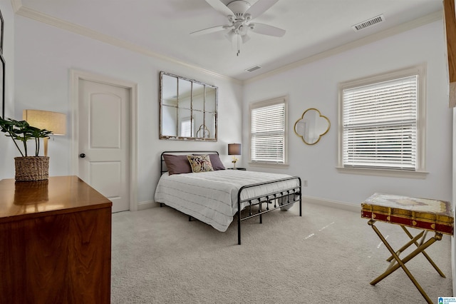 carpeted bedroom with crown molding, visible vents, and baseboards