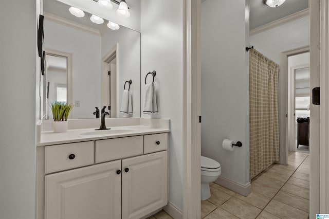 full bath with toilet, tile patterned floors, crown molding, baseboards, and vanity