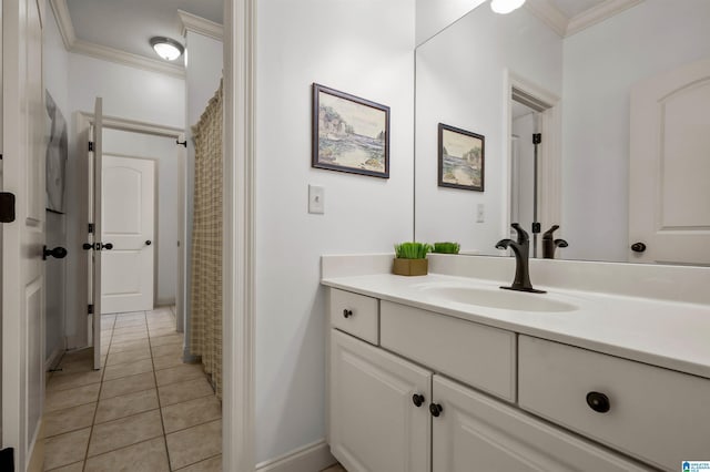 bathroom with crown molding, baseboards, tile patterned flooring, and vanity