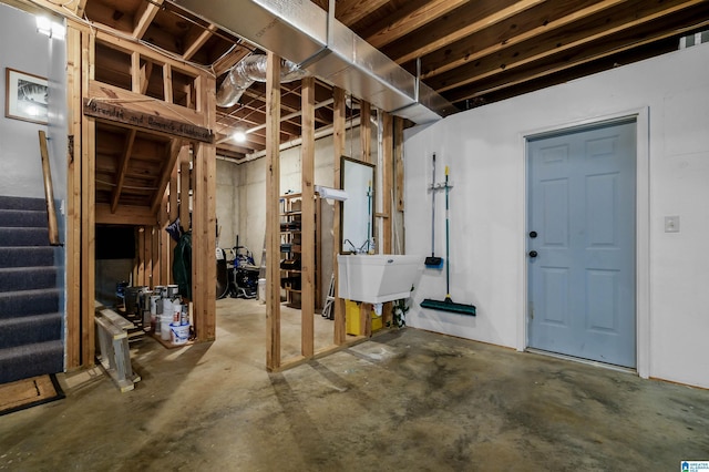 unfinished below grade area with stairs and a sink