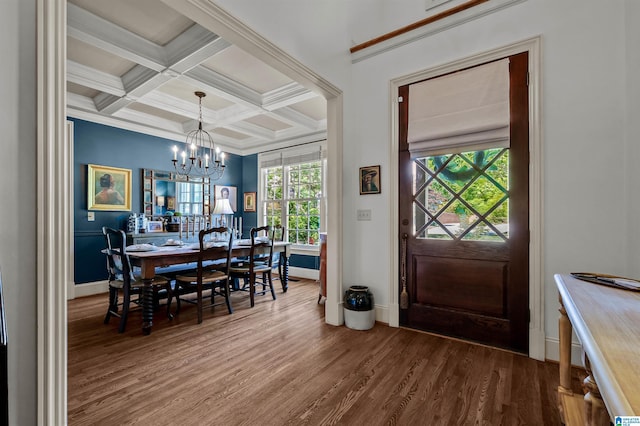 foyer entrance with an inviting chandelier, beam ceiling, plenty of natural light, and wood finished floors