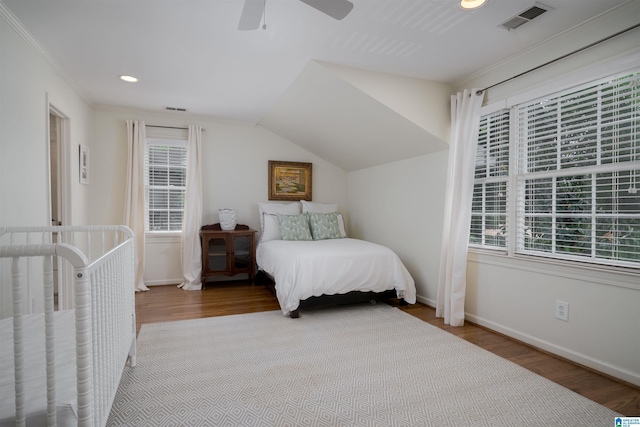 bedroom featuring baseboards, visible vents, and wood finished floors