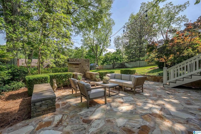 view of patio / terrace with a fenced backyard, an outdoor living space, and stairway
