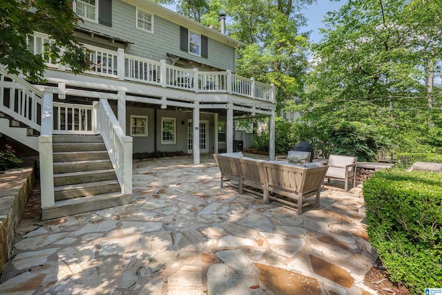 view of patio featuring stairs, an outdoor living space, and a deck