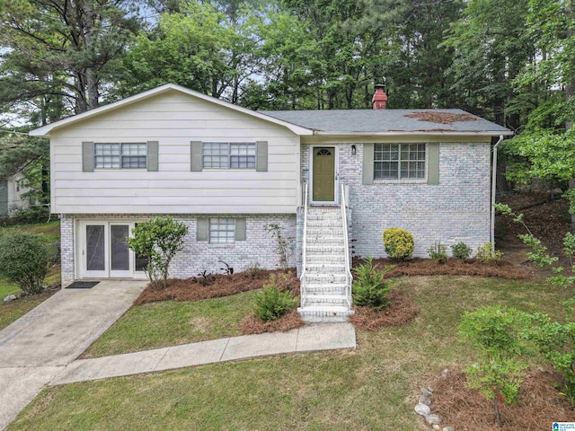 603 Danton Ln, Irondale, AL 35210 - view of front of house with a chimney, a front yard, and brick siding