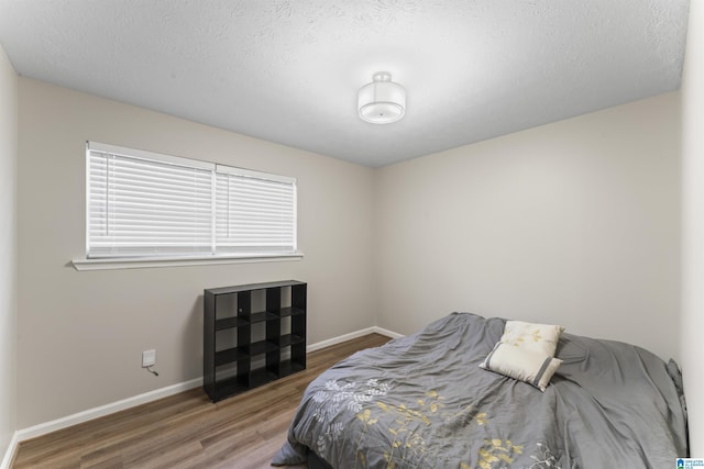 603 Danton Ln, Irondale, AL 35210 - bedroom with a textured ceiling, baseboards, and wood finished floors
