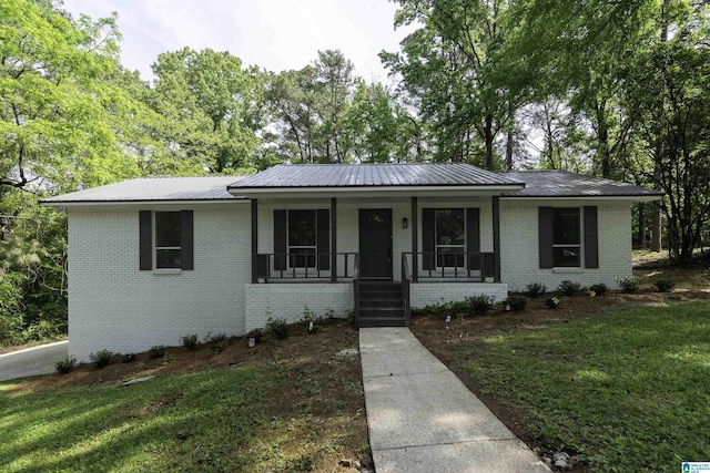 1006 Cannon Cir, Birmingham, AL 35235 - ranch-style home with a porch, brick siding, metal roof, and a front yard