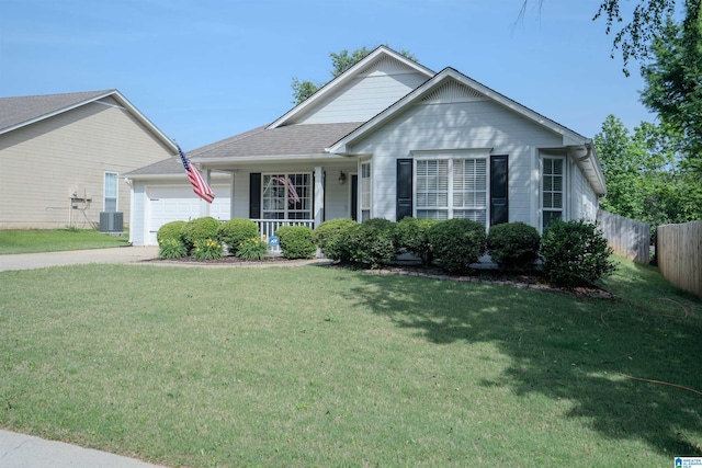 ranch-style house with an attached garage, fence, and a front lawn