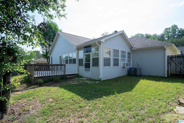 rear view of property with roof with shingles, fence, a yard, and a deck