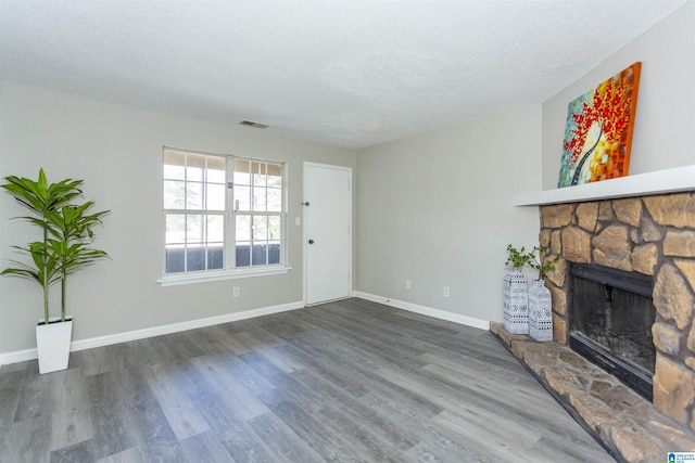 708 Patton Chapel Way Unit 708, Hoover, AL 35226 - unfurnished living room with visible vents, a textured ceiling, wood finished floors, and a fireplace