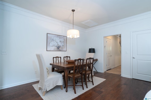dining space featuring dark wood-style flooring, baseboards, visible vents, and ornamental molding